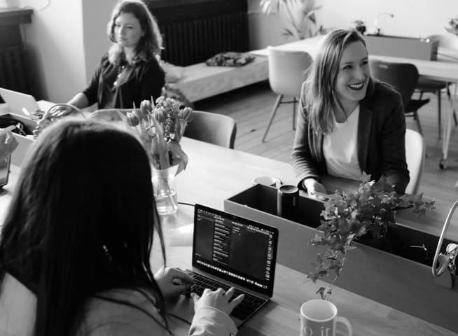 Pretty womens talking and laughing in an office environment